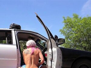 Une mignonne aux cheveux roses baise une bite de flic en plein air. La